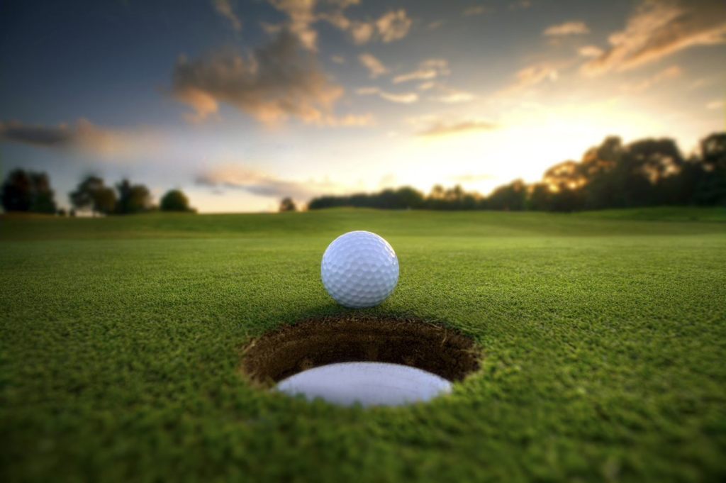 golf ball at edge of hole