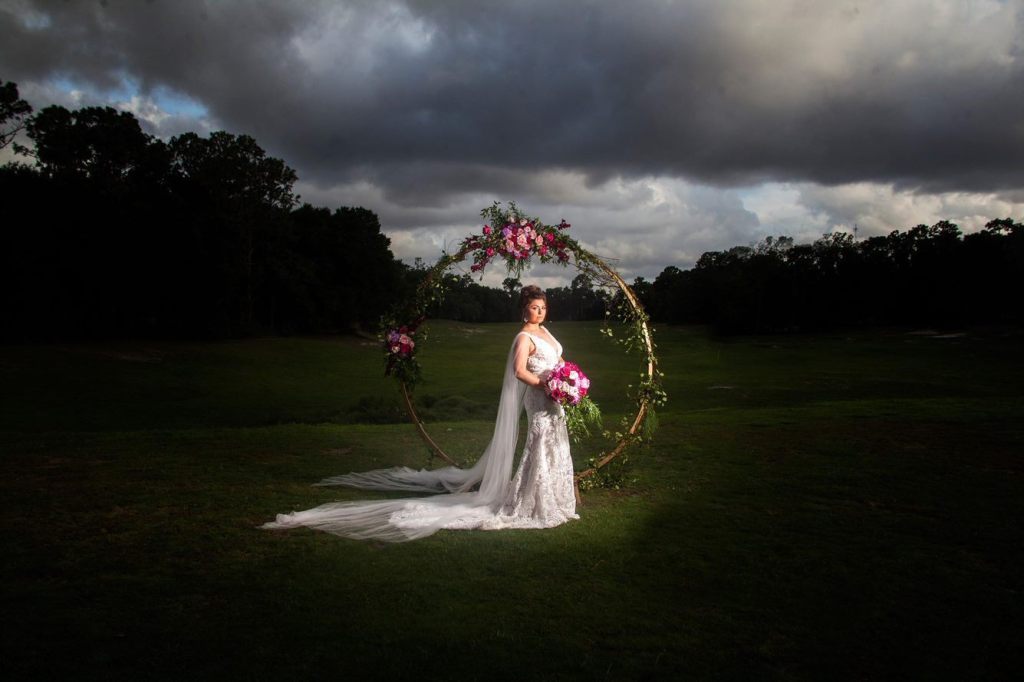 view of bride on golf course with flowers