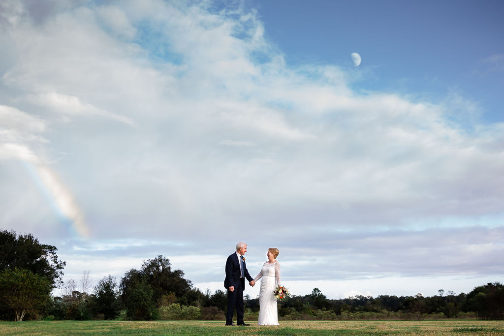 bride and groom with beautiful sky
