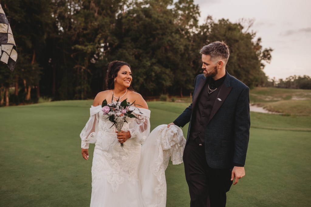 bride and groom walking on fairway